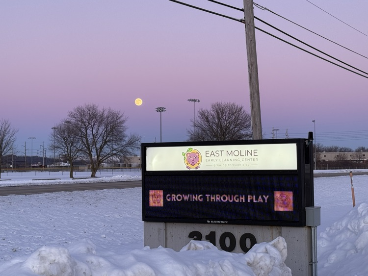 winter full moon over school sign
