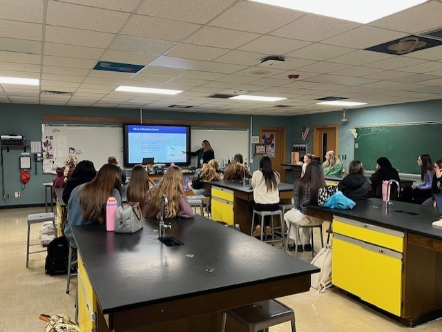 a nurse teaching a classroom of students