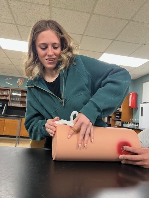 student packing fake wound