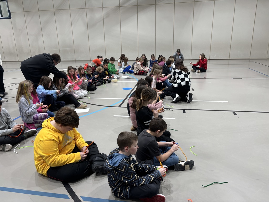 A group of students working on a pipe cleaner project