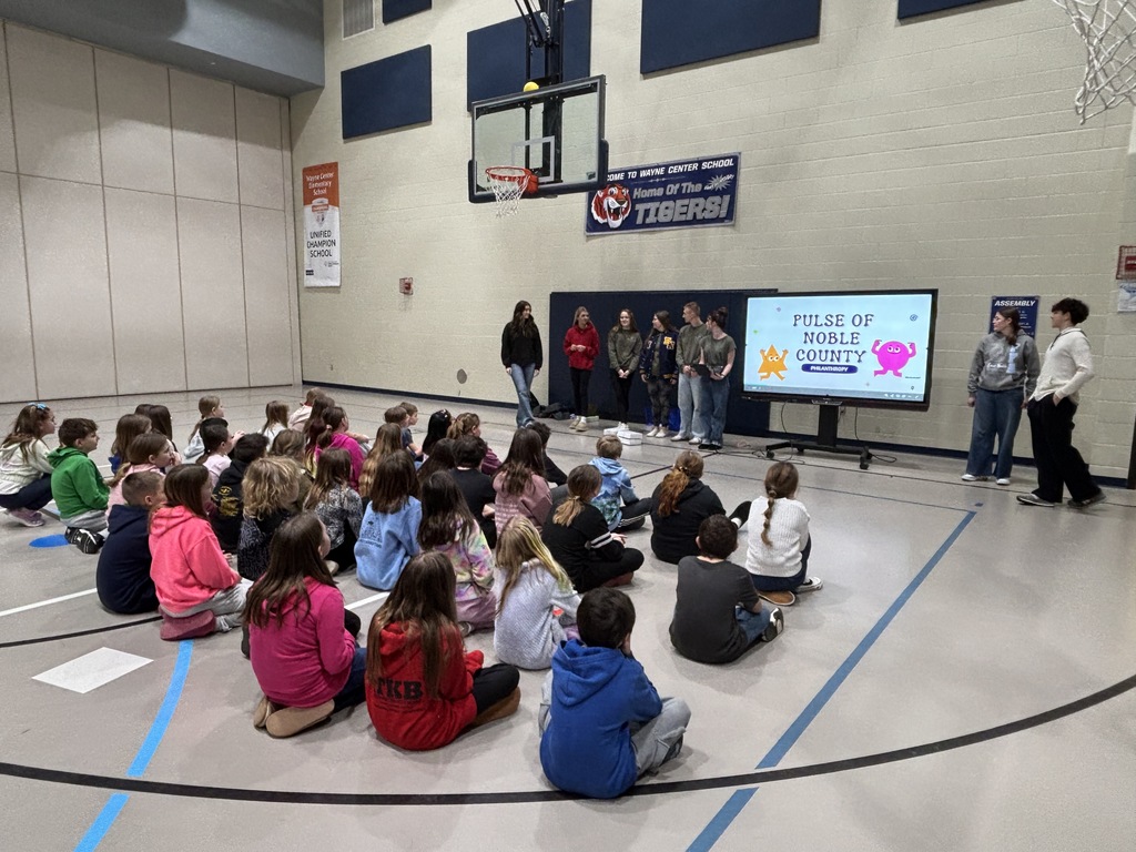 high school students presenting to 4th graders