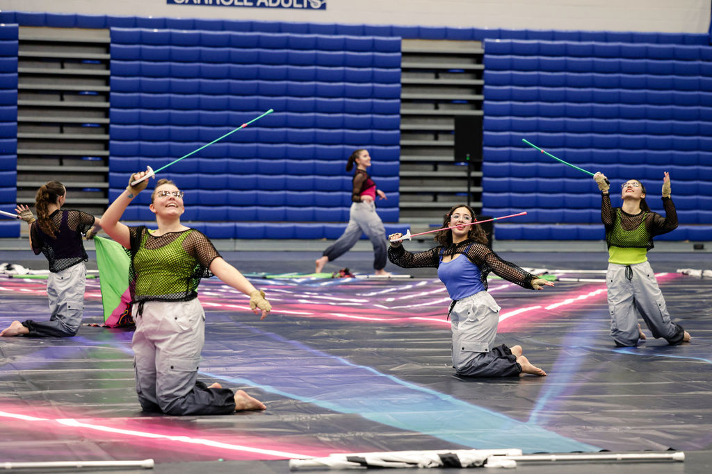 winter guard members practicing with prop swords