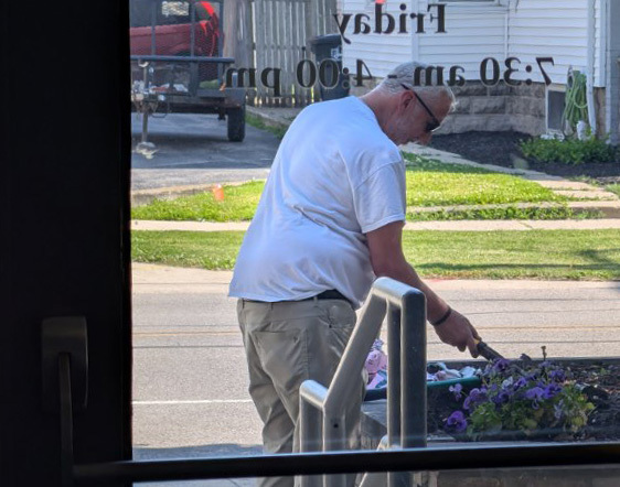 Superintendent Steve Planting Flowers