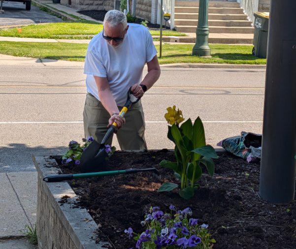Superintendent Steve Planting Flowers