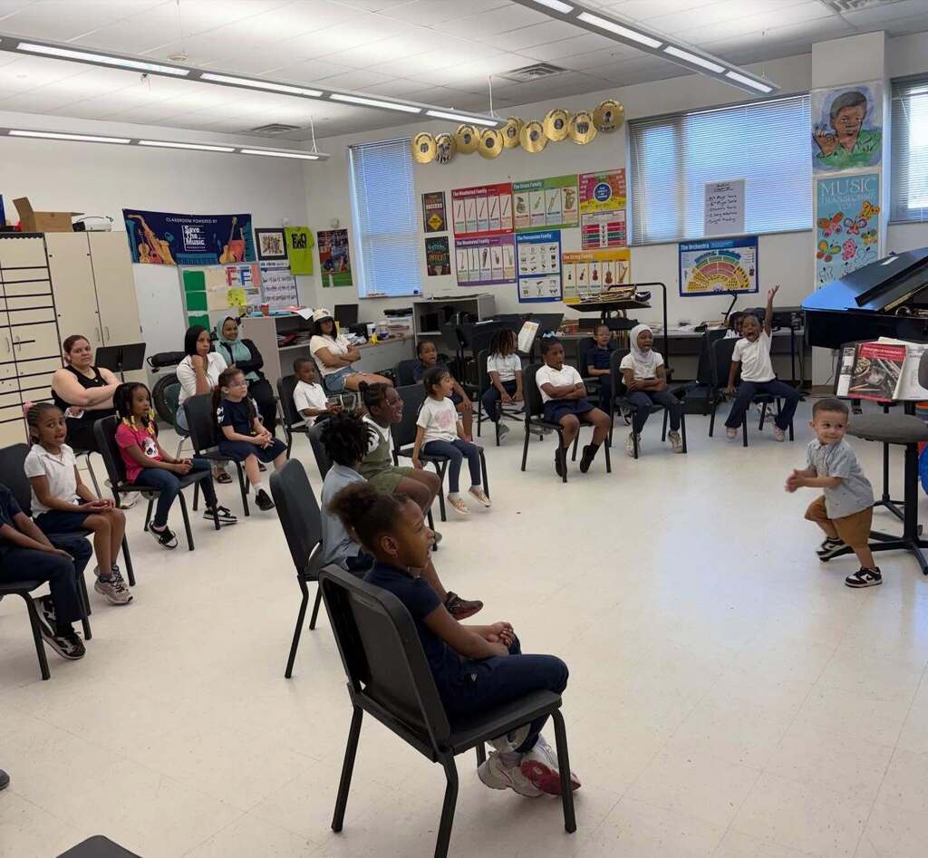 Group of children sitting in a circle in music class