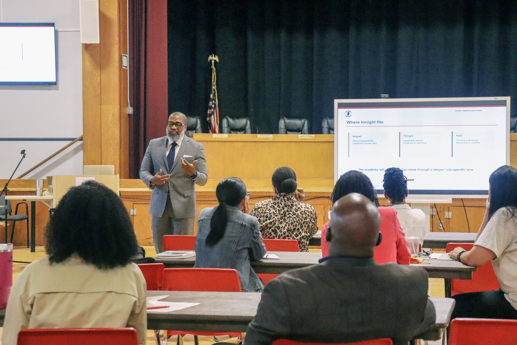 Dr.Taylor talking to a group of staff