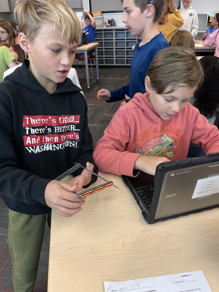 two students working together to test materials