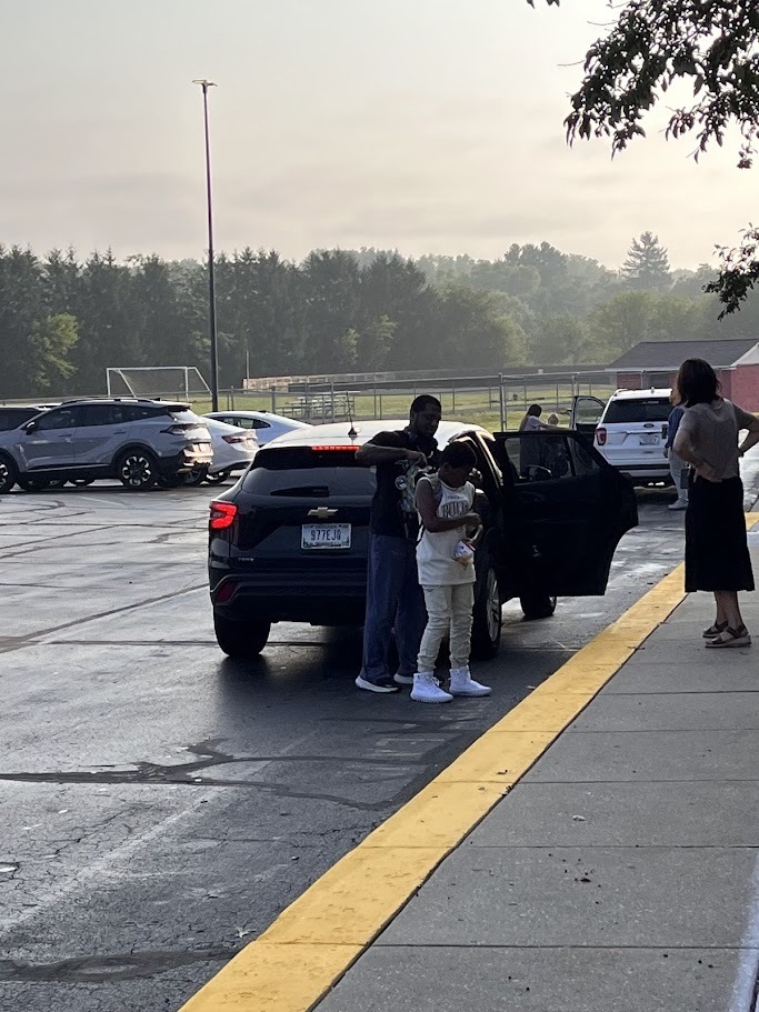 Dad helping son at drop off