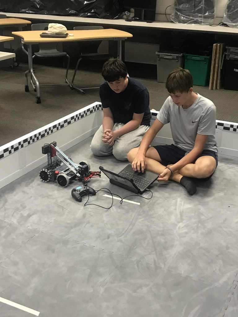 Secondary students working with robots