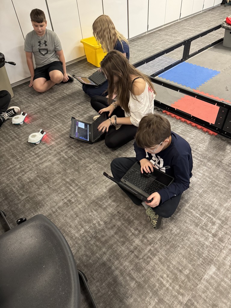 Secondary students working with robots