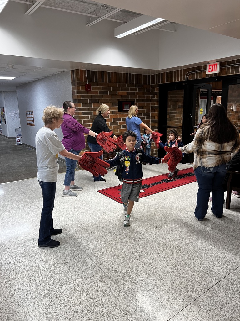 howard center staff giving high fives to students coming into school