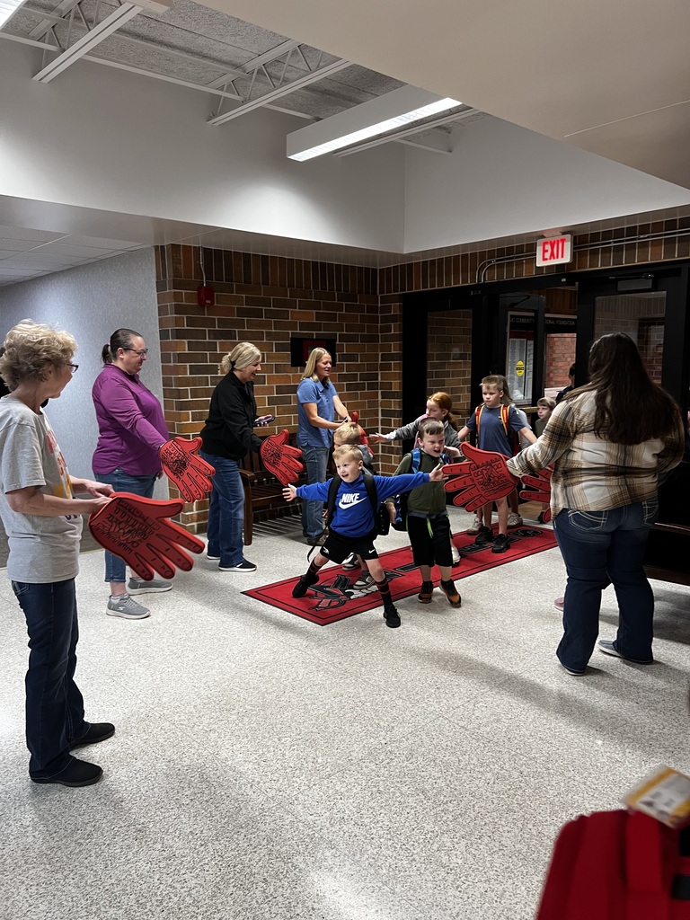 howard center staff giving high fives to students coming into school