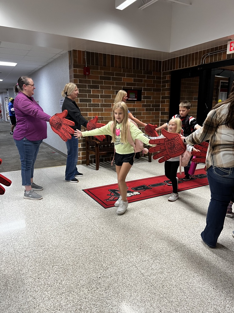 howard center staff giving high fives to students coming into school