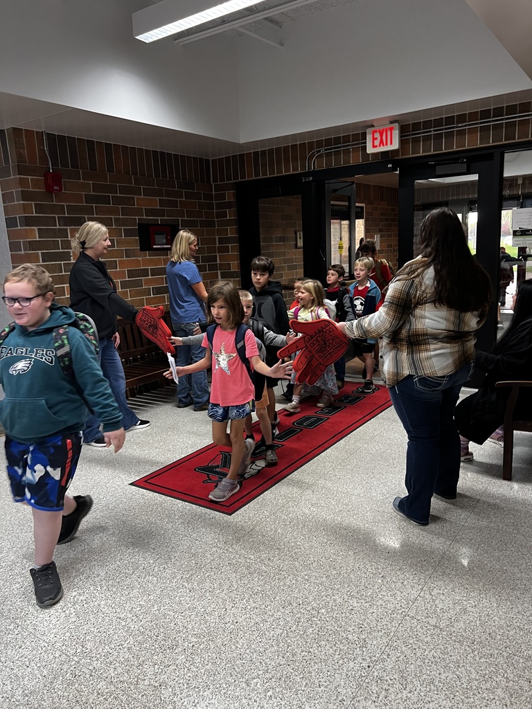 howard center staff giving high fives to students coming into school