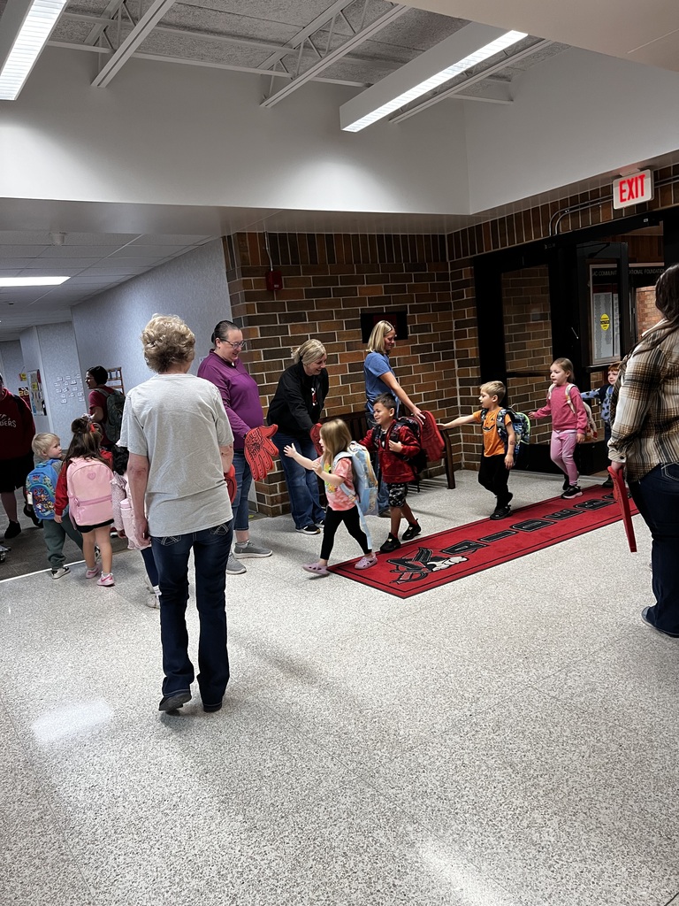 howard center staff giving high fives to students coming into school