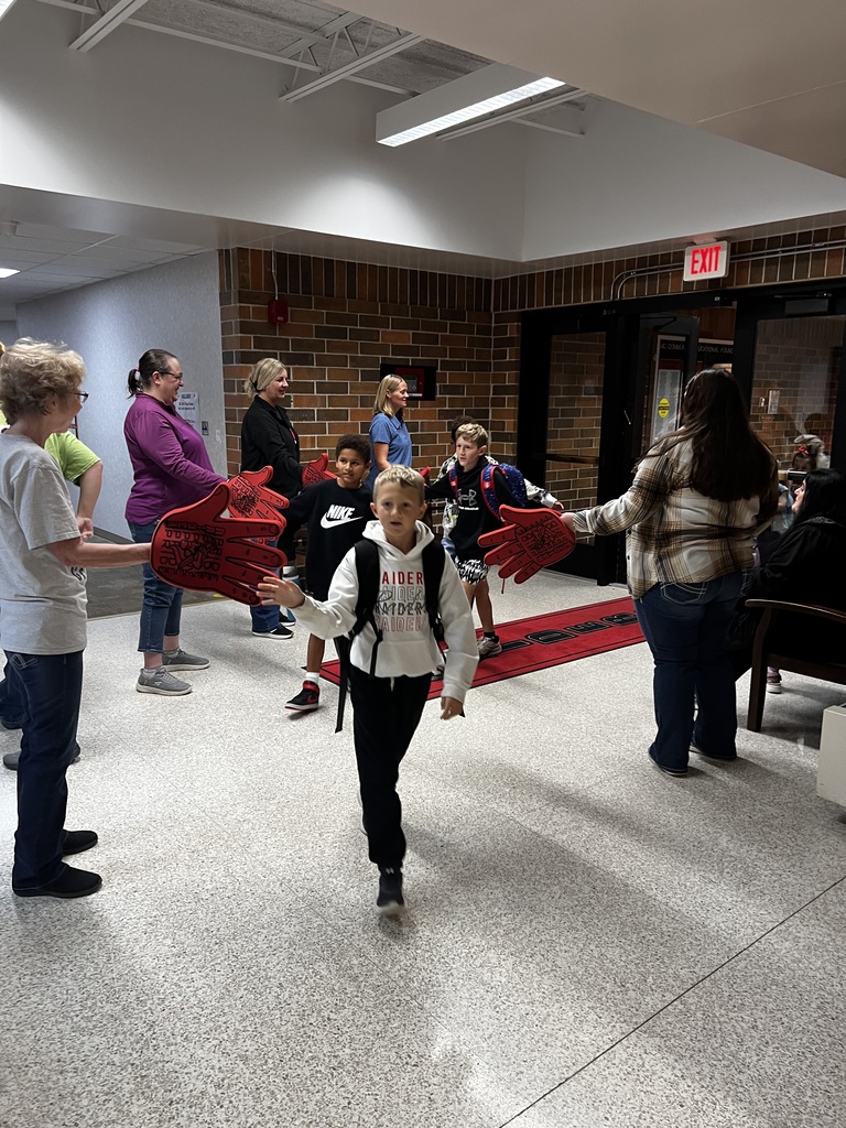 howard center staff giving high fives to students coming into school