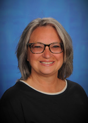 woman in front of a blue backdrop