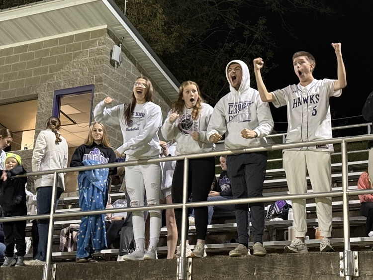 group of students cheering on their football team