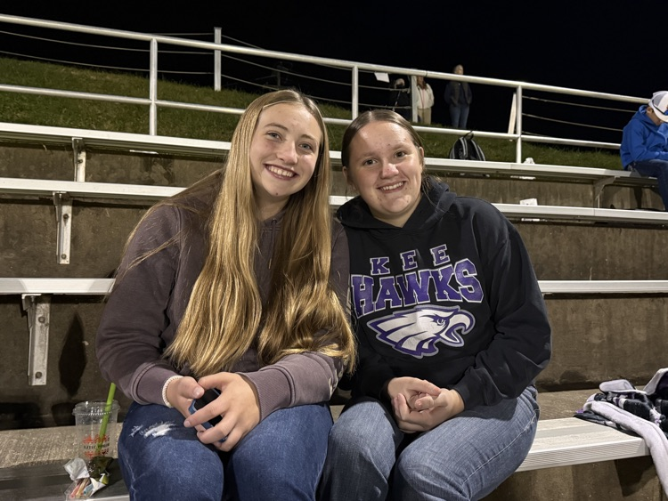 two girls huddled together smiling