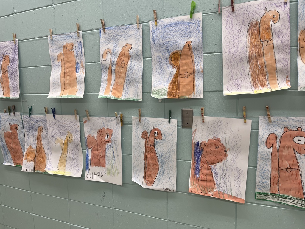 Art projects depicting squirrels hanging  on a mint colored wall 