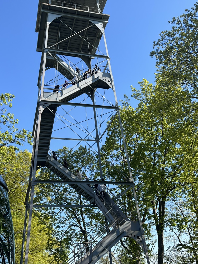 students claiming a metal tower