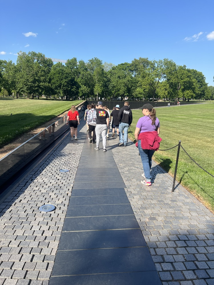 students in walking the path of the Vietnam wall