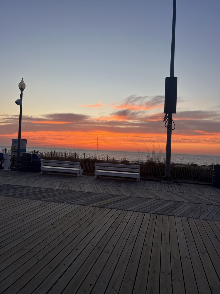 Rehoboth beach with an orange skyline in the morning