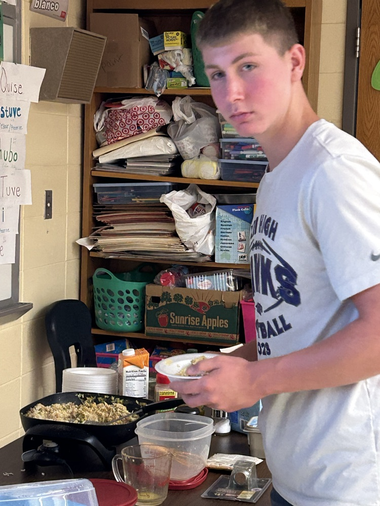 Student getting serving of rice dish
