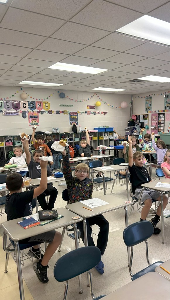 Students Holding Up Doughnuts