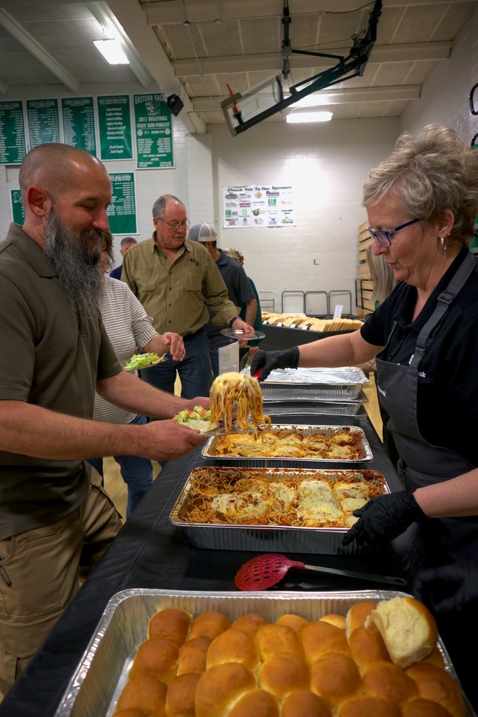 people at the banquet being served their meals. 