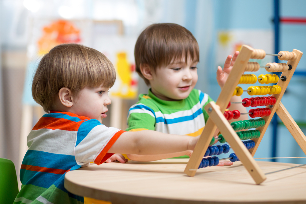 Two children playing with colorful blocks