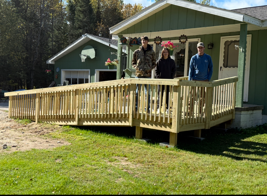 three students standing on deck ramp