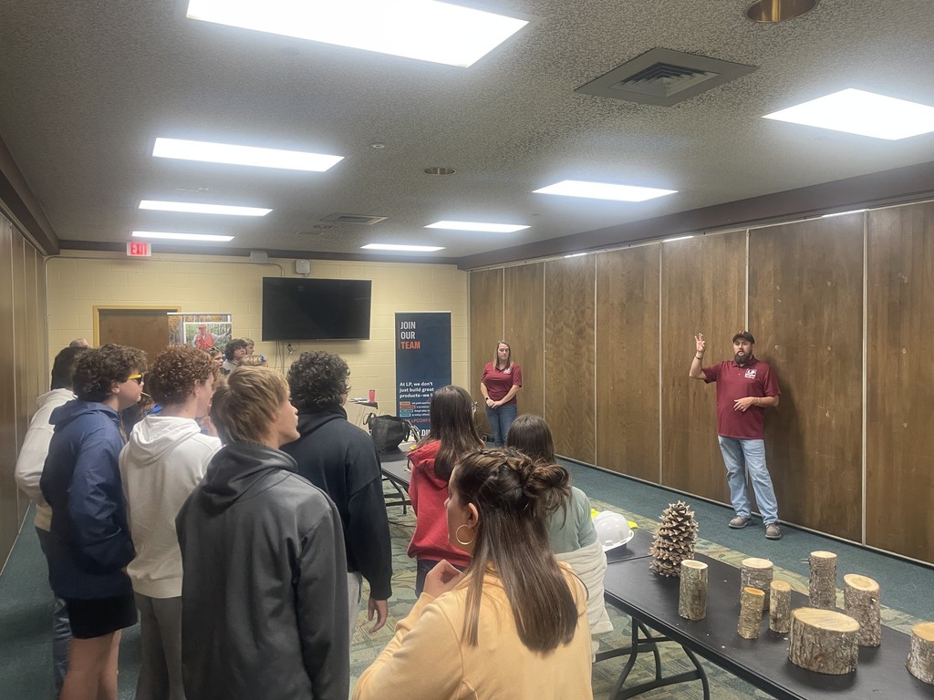 one man, one woman giving presentation to students