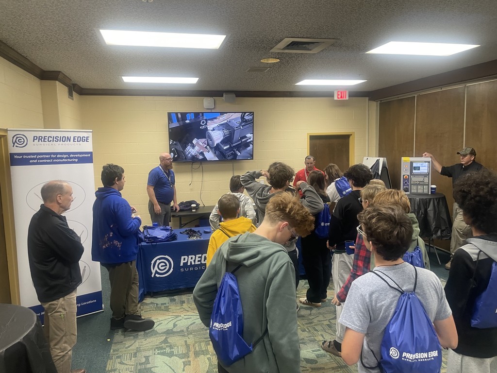 two men giving presentation to students