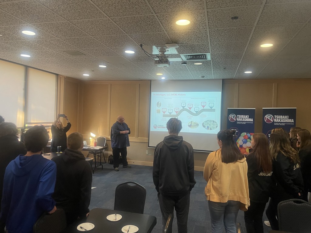 man presenting to students