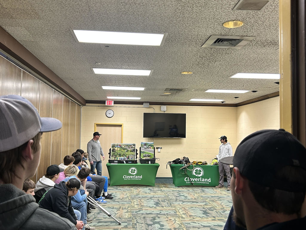 two men giving presentation to students