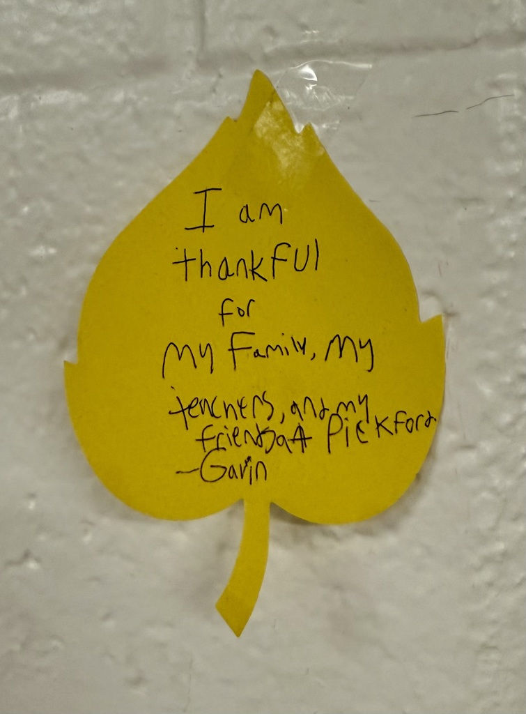A yellow construction paper leaf. A student's handwriting reads: "I am thankful for my family, my teachers, and my friends at Pickford.