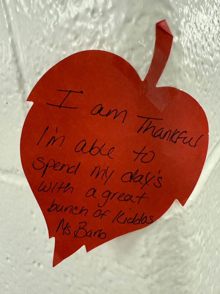 A bright red constuction paper leaf. The handwriting reads "I am thankful I'm able to spend my days with a great bunch of kids."