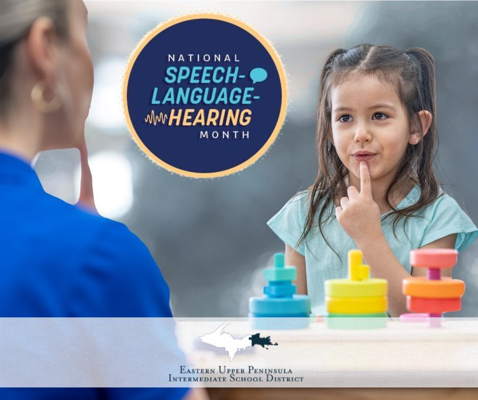 A young girl points to her mouth. There is a therapist facing her making the same motion. Text reads "National Speech Language Hearing Month." 