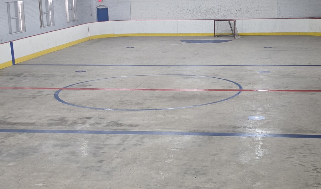 An ice hockey rink with freshly painted red and blue lines.