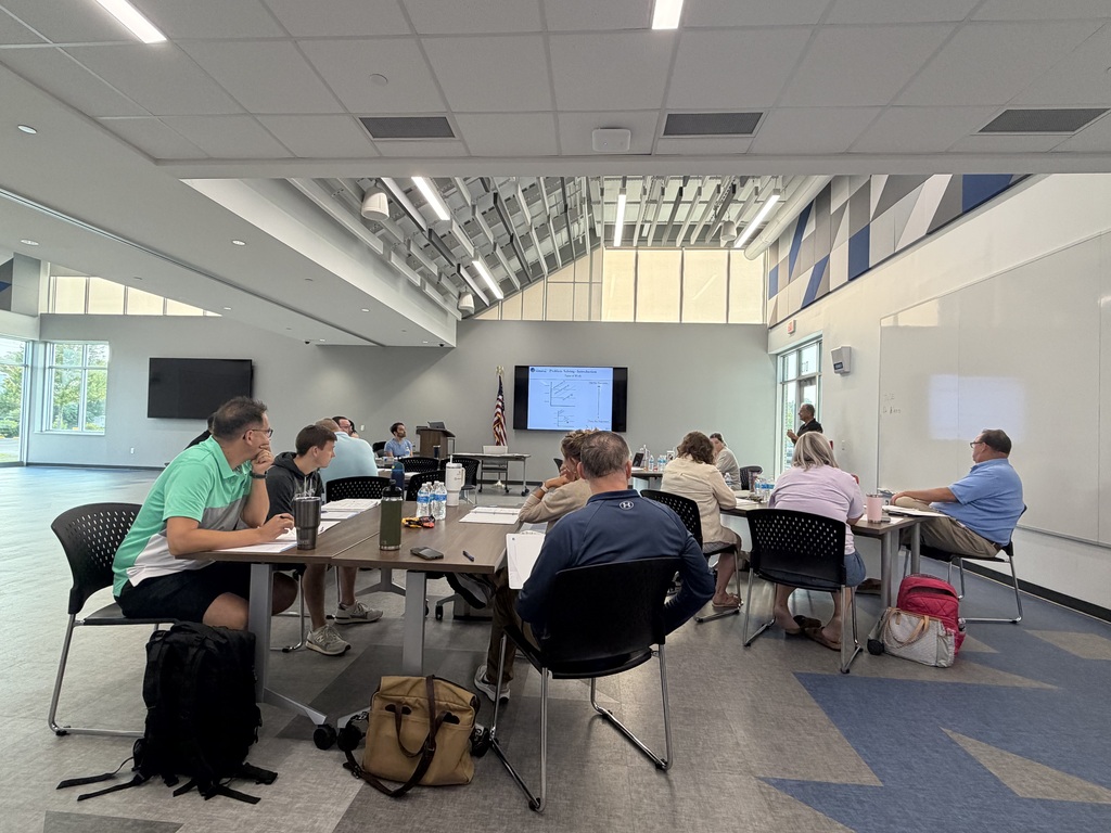 Adult educators sitting in a classroom learning. 