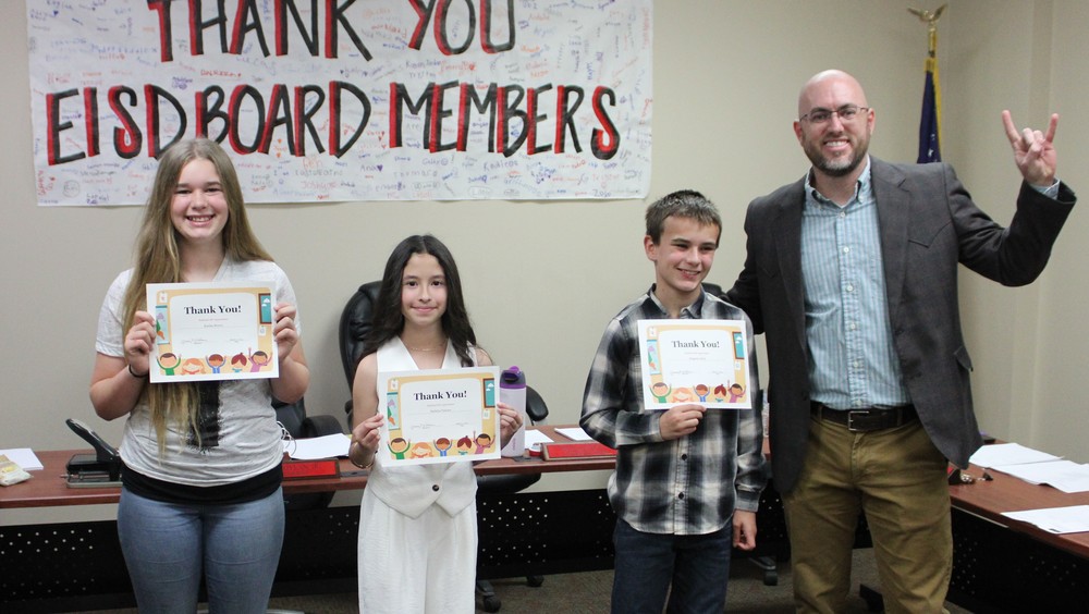 Kimber, Madelyn, and Kingston lead pledge at March School Board Meeting!