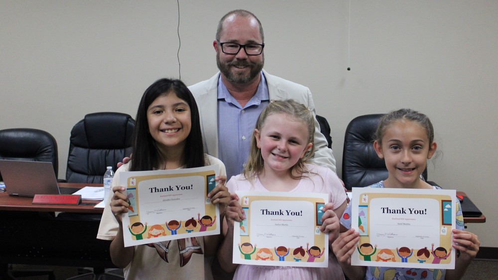 Alondra, Jaelyn, and Ariel lead pledge at September School Board Meeting!