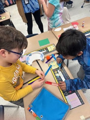 Second grade students working together on their literacy/stem project.