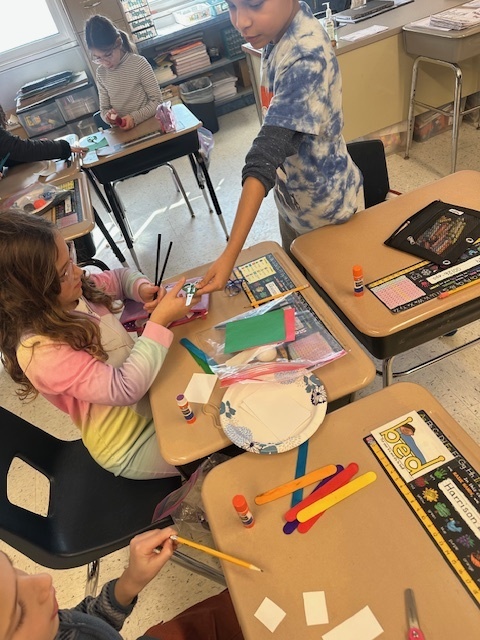 Second grade students working together on their literacy/stem project.