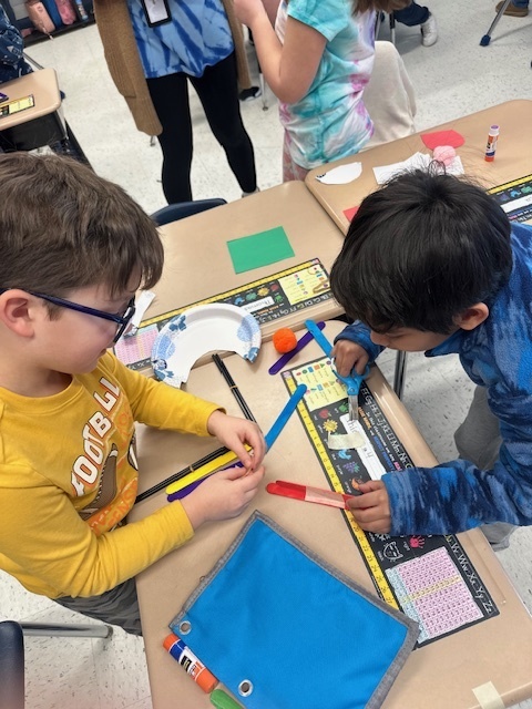 Second grade students working together on their literacy/stem project.