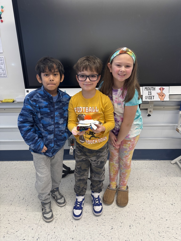 Second grade students showing their "Things That Go Places" creation. 