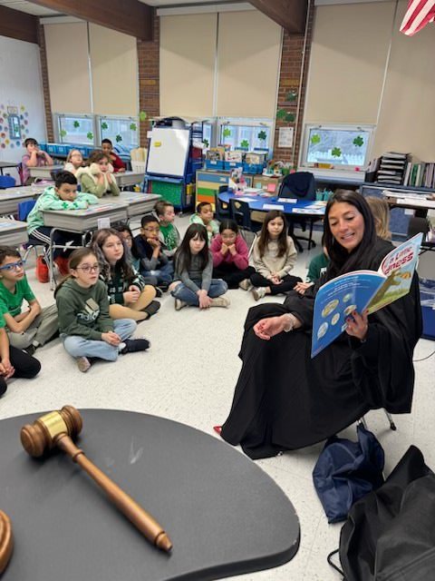 Jude Russell reads to third grade students for Read Across America