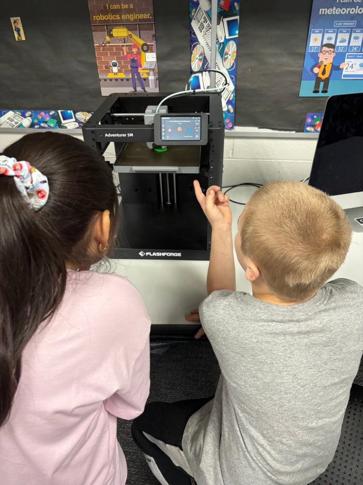 student observing 3D printer