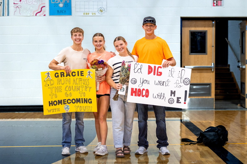 Garrett Pumphrey, Gracie Long, Morgan Rea, and Tyler Gillespie Stand Together with Poster Asking Morgan and Gracie to the Homecoming Dance